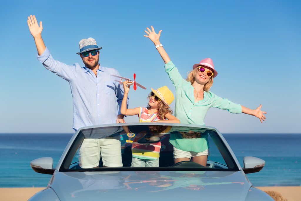 Happy family travel by car by the sea